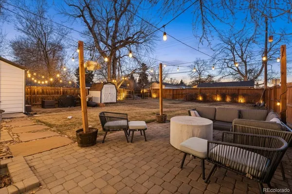 a view of a patio with iron fence