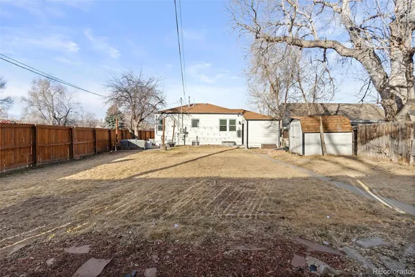 a view of backyard with outdoor and green space
