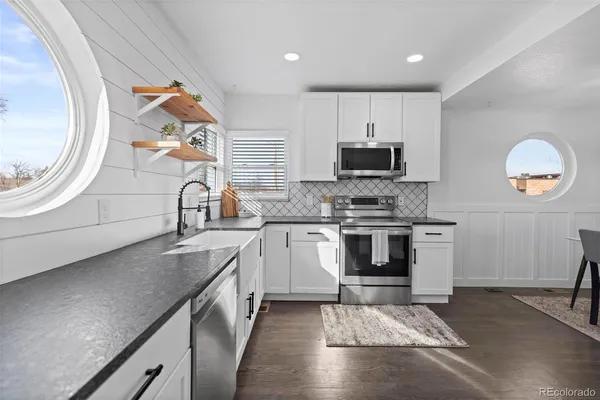 a kitchen with granite countertop a stove and a sink