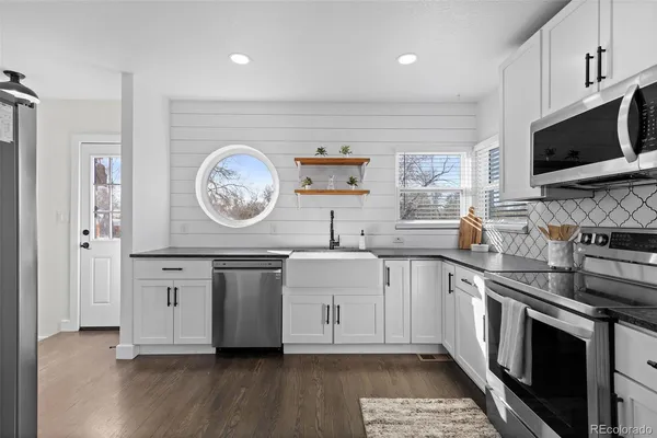 a kitchen with stainless steel appliances a stove microwave and a refrigerator