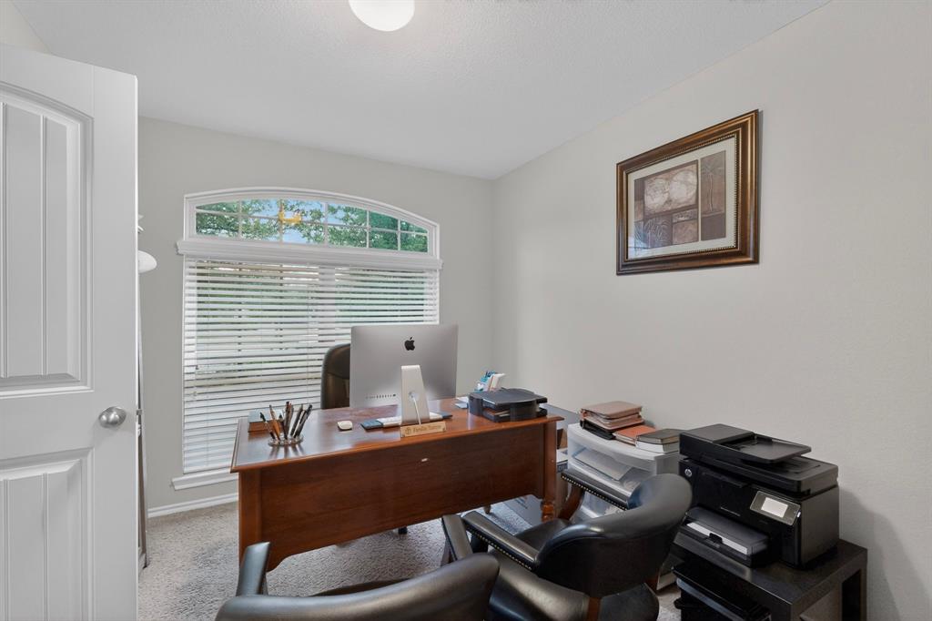 1409 Slate Street Princeton, TX 75407 - Photo 28 of 36 Room featuring a large arched window with horizontal blinds, light gray wall paint, and gray carpeting
