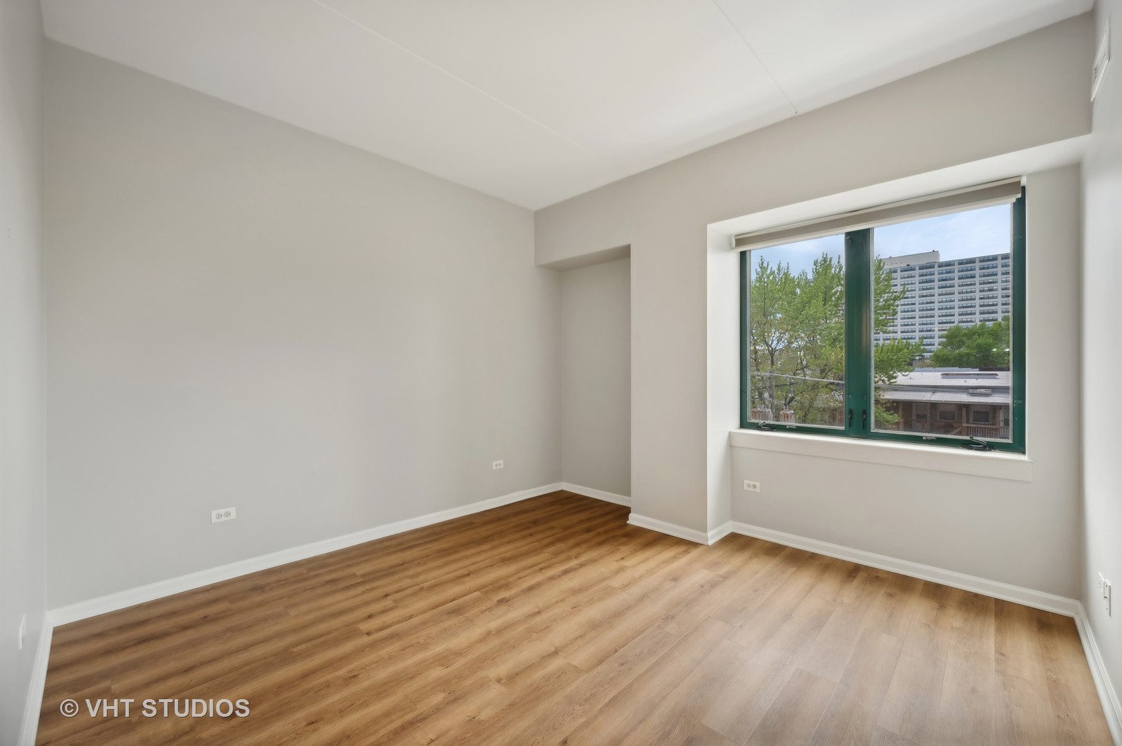 4848 North Sheridan Road, Unit 403 Chicago, IL 60640 - Photo 14 of 21 a view of an empty room with wooden floor and a window