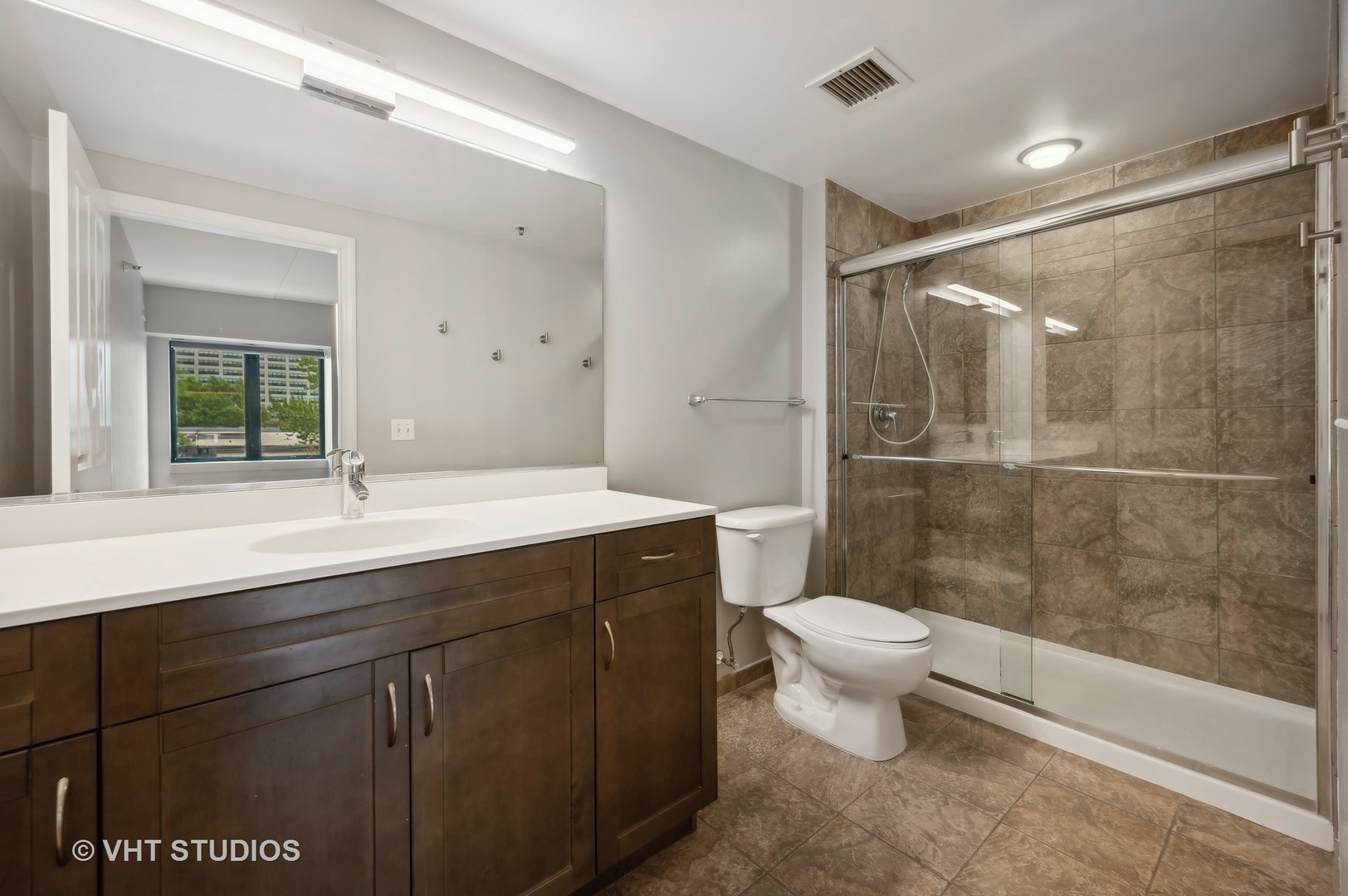 4848 North Sheridan Road, Unit 403 Chicago, IL 60640 - Photo 16 of 21 a bathroom with a sink toilet and shower