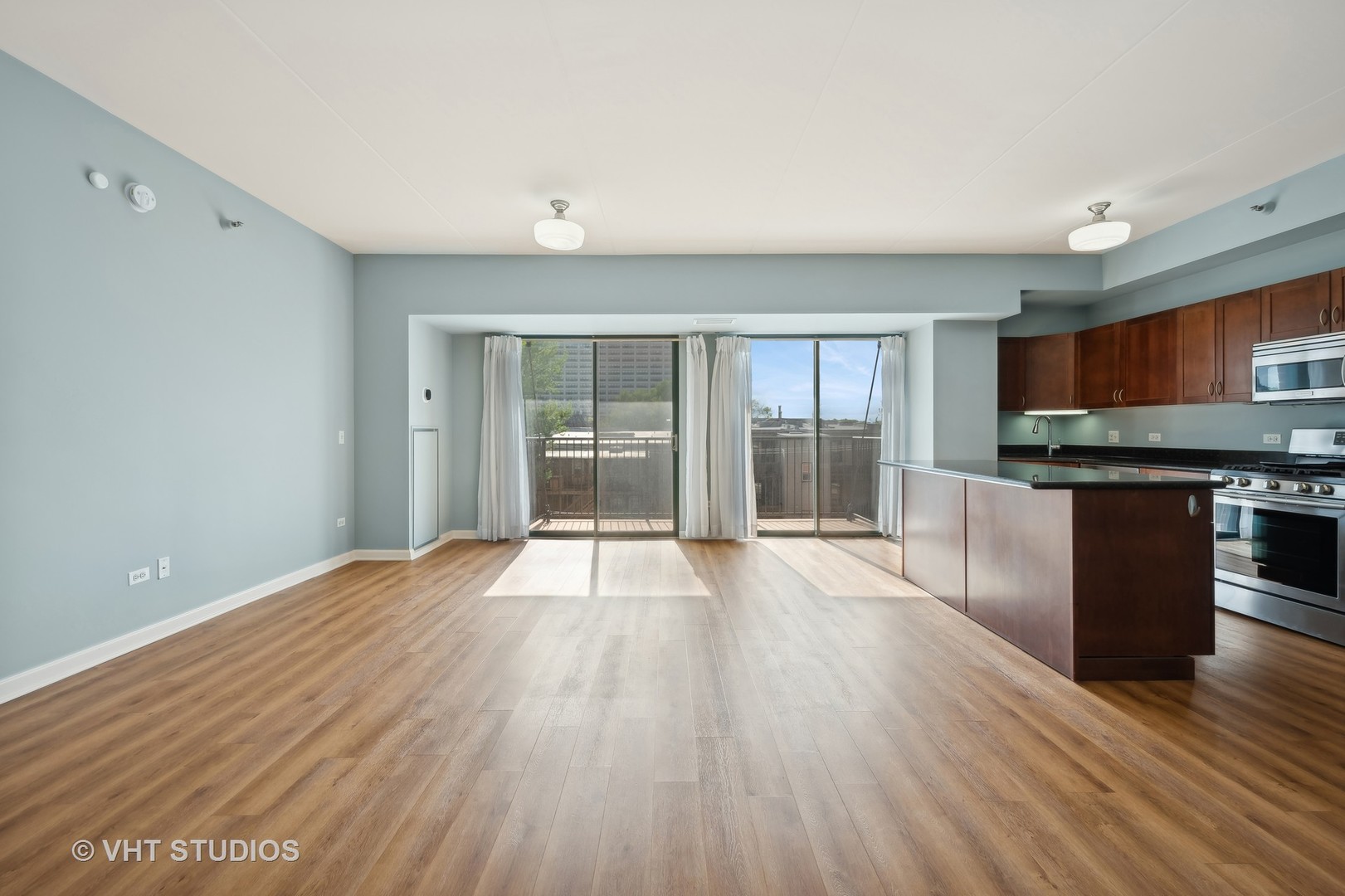 4848 North Sheridan Road, Unit 403 Chicago, IL 60640 - Photo 7 of 21 a view of a kitchen with wooden floor and a sink
