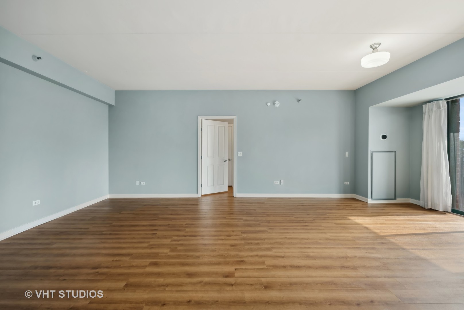 4848 North Sheridan Road, Unit 403 Chicago, IL 60640 - Photo 8 of 21 a view of an empty room with wooden floor