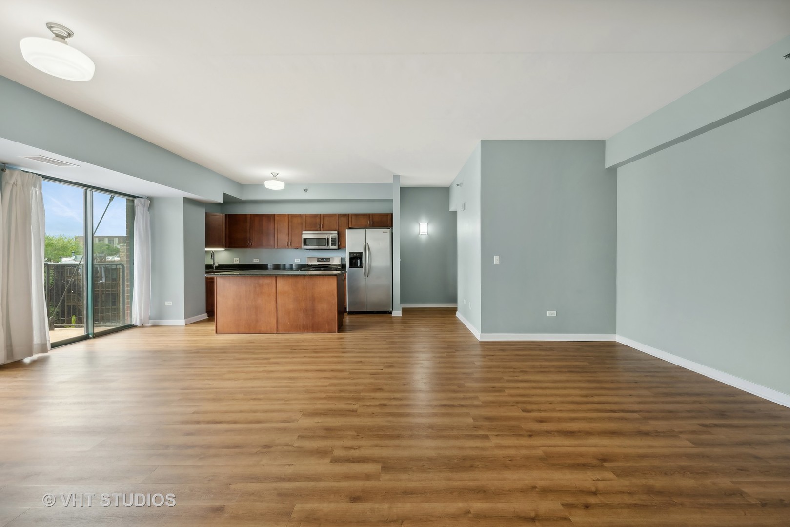 4848 North Sheridan Road, Unit 403 Chicago, IL 60640 - Photo 10 of 21 a view of a kitchen with a sink and a large window