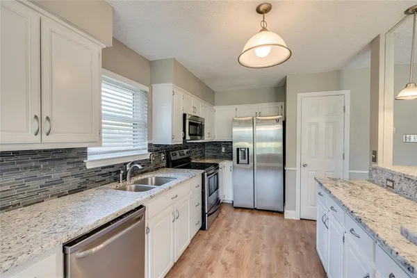 a bathroom with a granite countertop sink toilet a mirror and shower