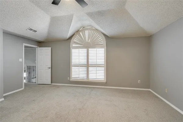 a view of an empty room and a window