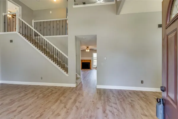 a view of a hallway view with wooden floor and staircase