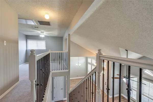an empty room with a window and ceiling fan