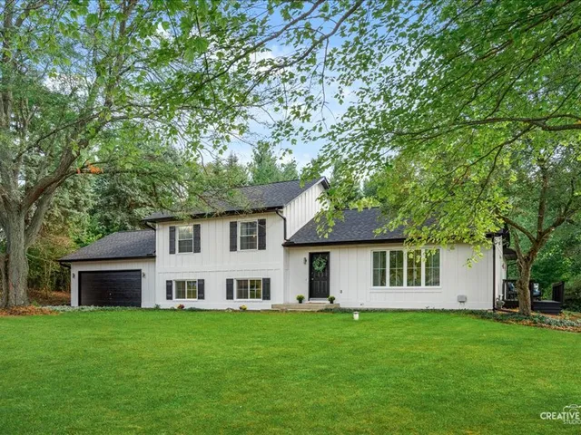 a front view of a house with a garden
