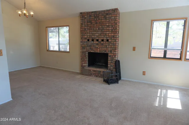 a view of empty room with a fireplace