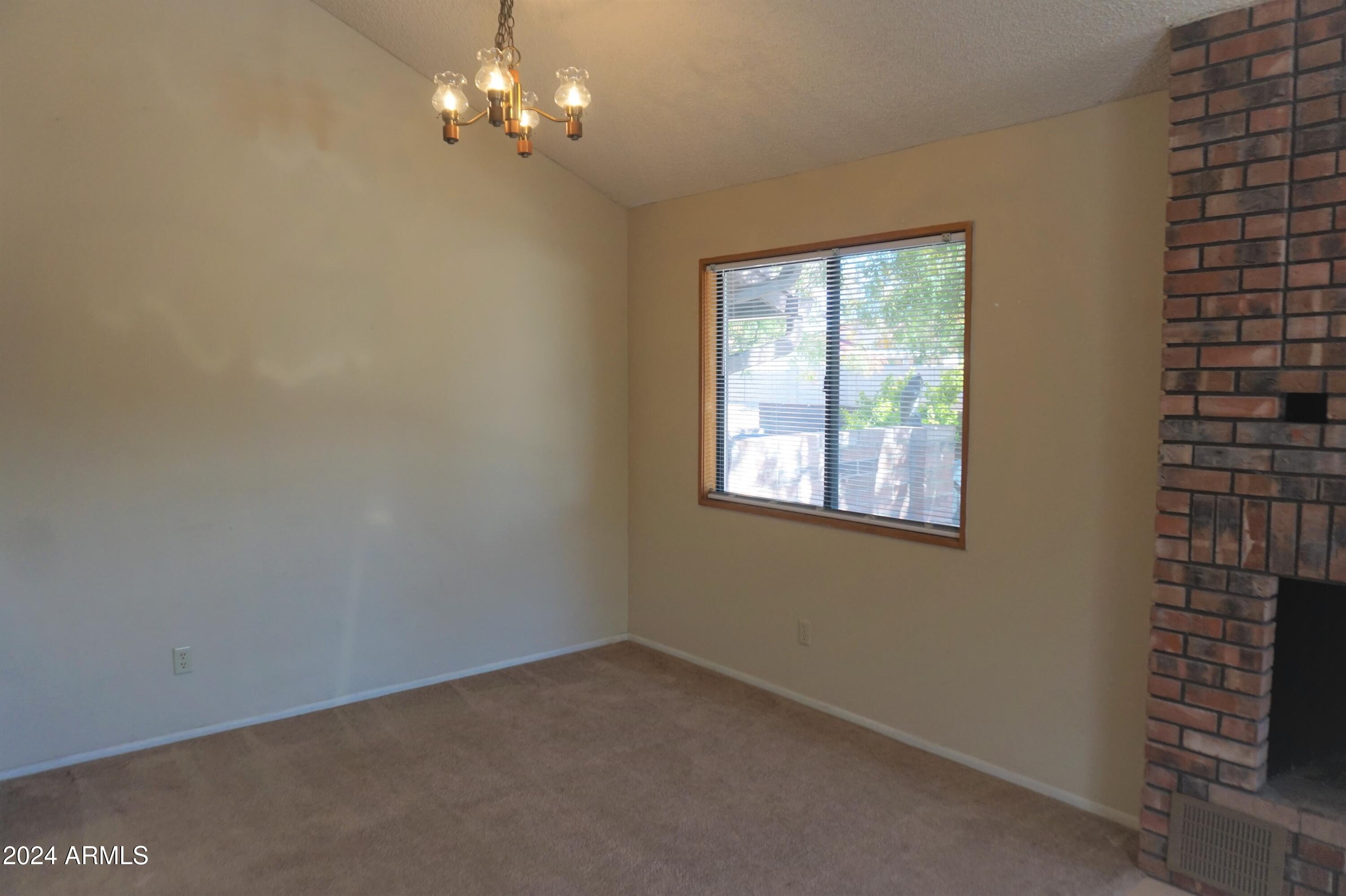 1762 Corte Encantada, Unit E Sierra Vista, AZ 85635 - Photo 4 of 10 a view of an empty room with a window