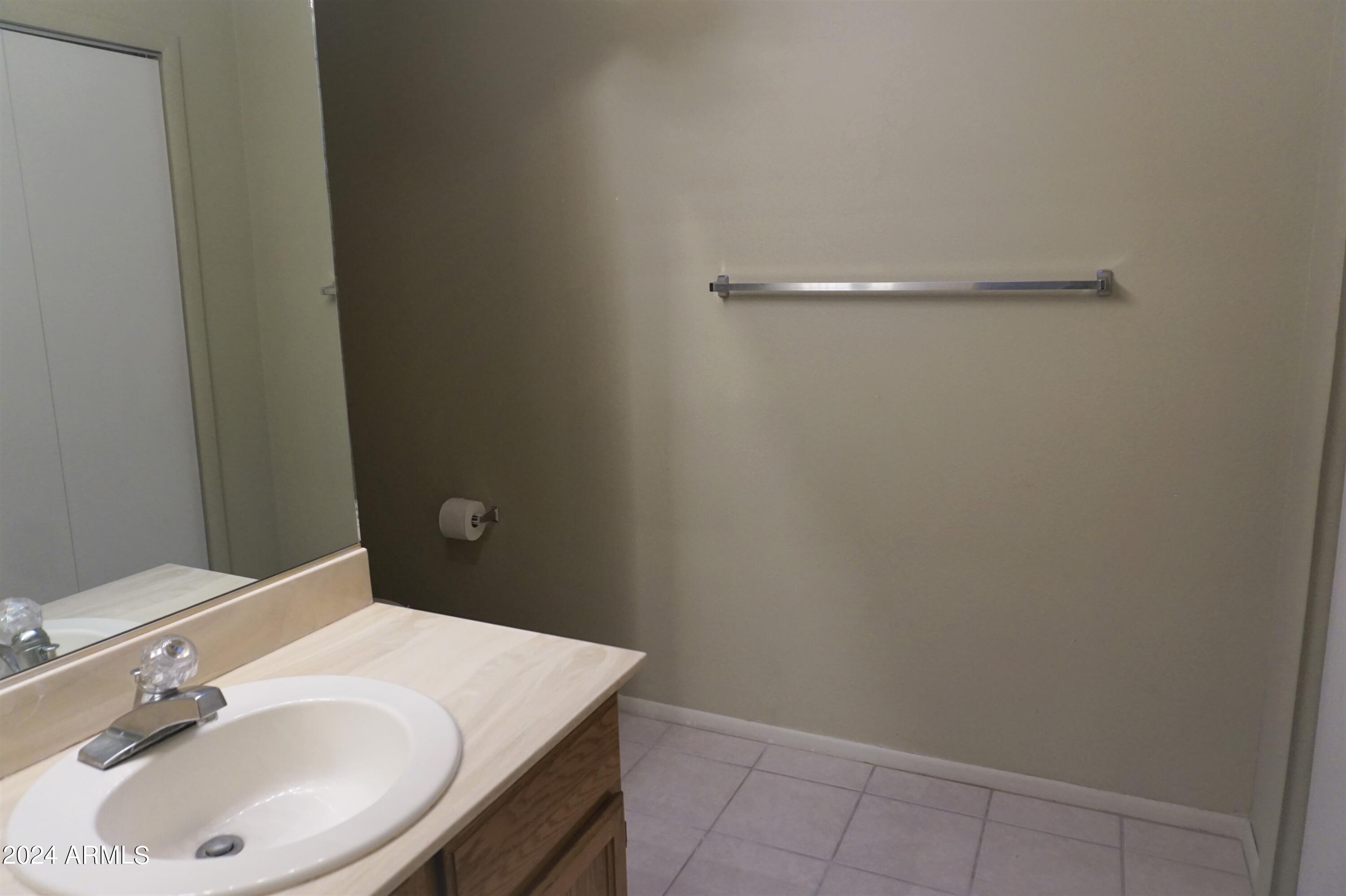 1762 Corte Encantada, Unit E Sierra Vista, AZ 85635 - Photo 7 of 10 a bathroom with a sink and vanity