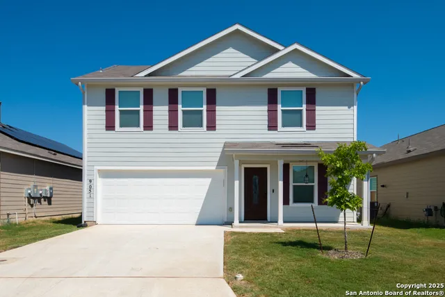 a front view of a house with a yard