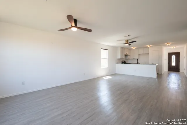 a view of a kitchen with a dishwasher cabinets and wooden floor