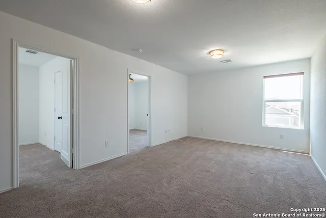 an empty room with windows and closet