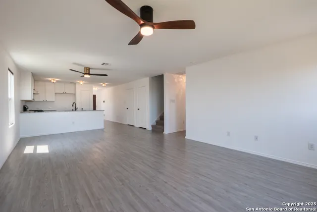 a view of a kitchen with a dishwasher and wooden floor