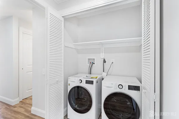 a view of a hallway with washer and dryer