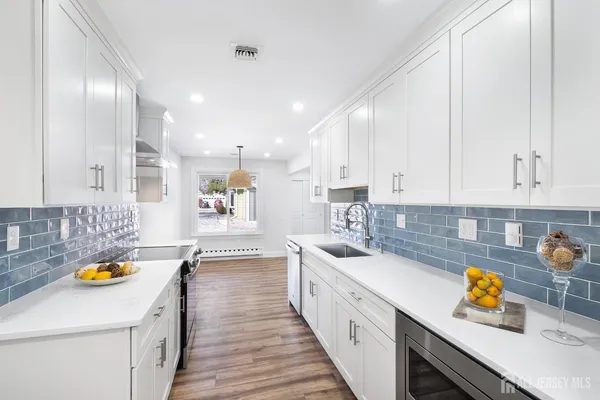 a kitchen with a sink a stove and cabinets