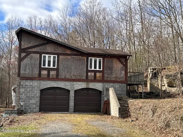 a front view of a house with parking space