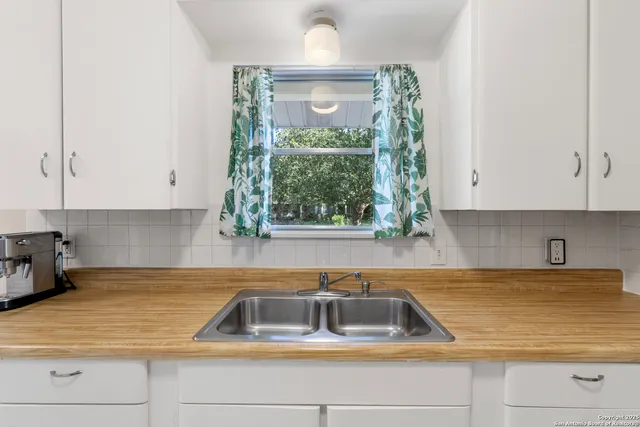 a kitchen with sink cabinets and window
