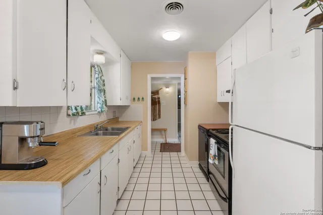 a kitchen with a sink stove and refrigerator