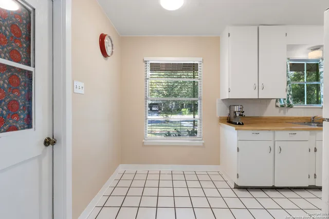 a kitchen with a sink cabinets and window