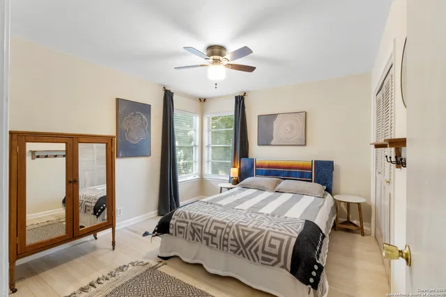 a bedroom with a large bed and a chandelier