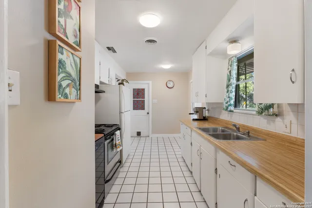 a spacious bathroom with a sink a mirror and a shower