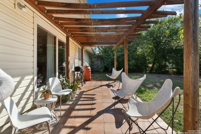 a view of a chairs and table in the patio