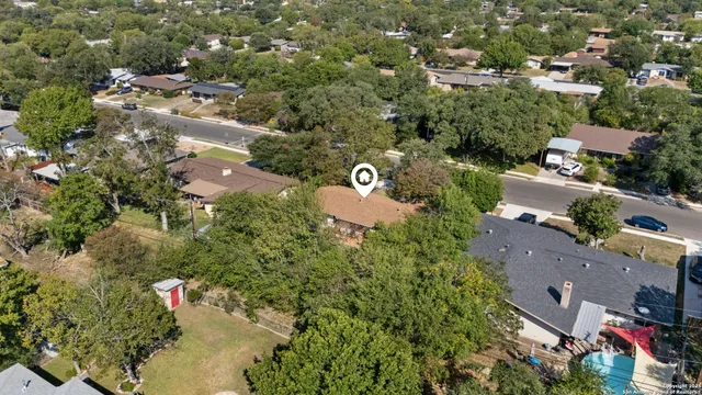 an aerial view of residential house with outdoor space and swimming pool
