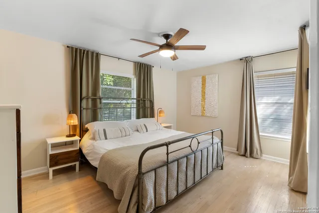 a bedroom with a bed and a large window