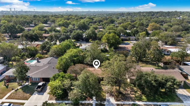 an aerial view of a forest with a yard
