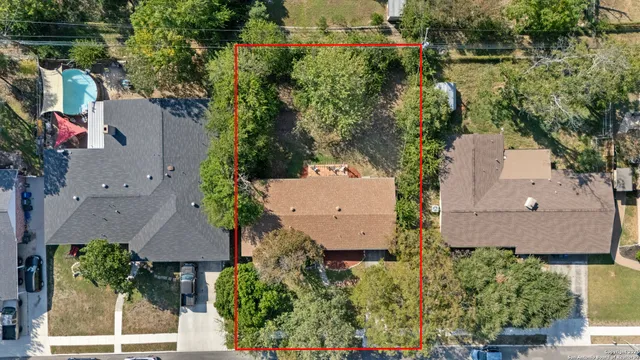 an aerial view of a house with a yard and lake view