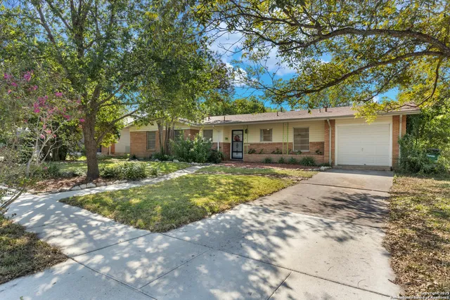 a view of house with swimming pool outdoor seating