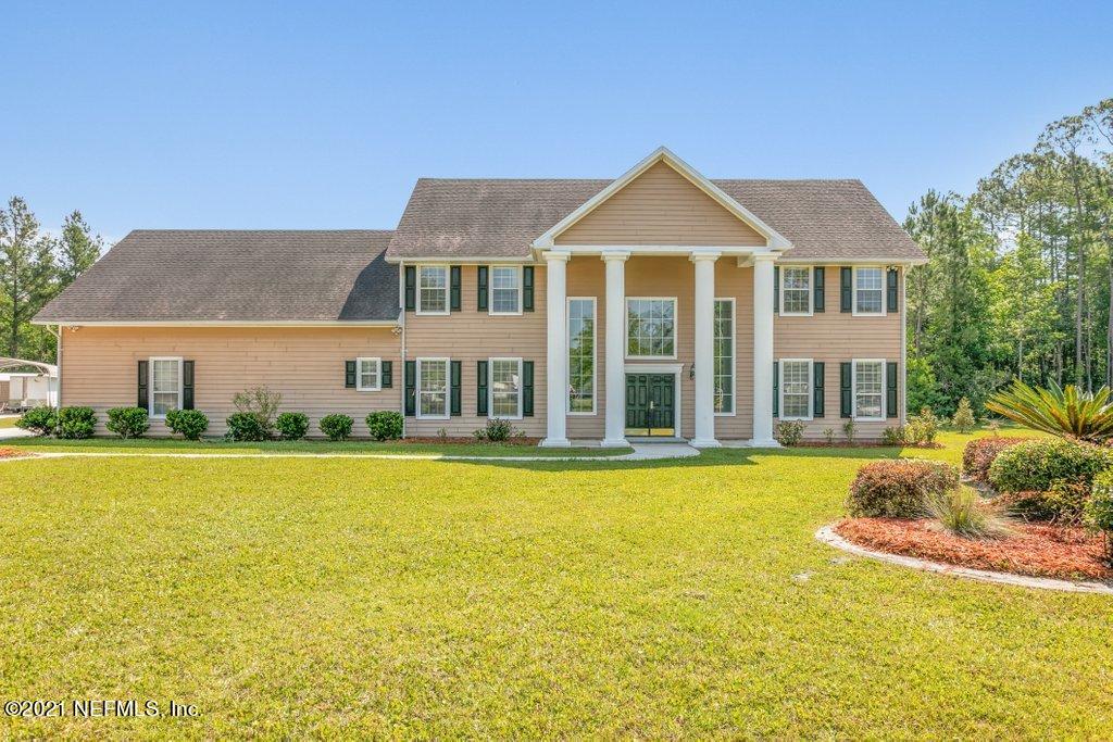 55268 Deer Run Road Callahan, FL 32011 - Photo 1 of 59 a front view of a house with swimming pool