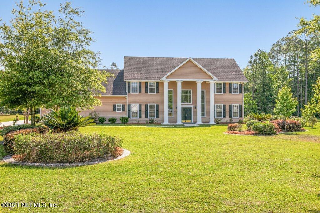 55268 Deer Run Road Callahan, FL 32011 - Photo 4 of 59 a view of a house with swimming pool and a yard