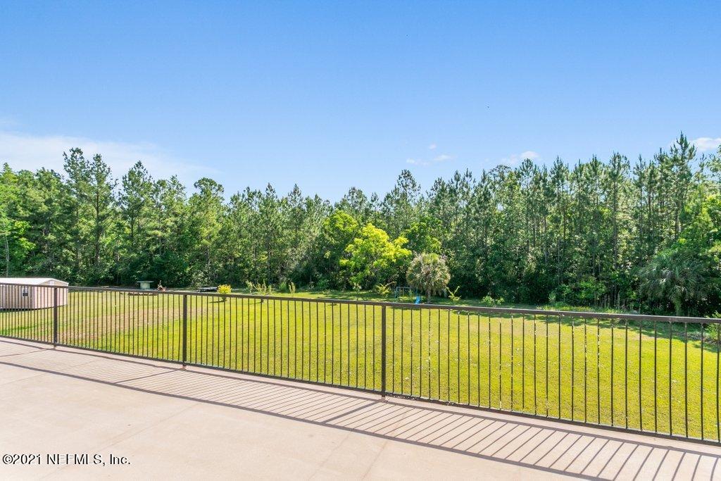 55268 Deer Run Road Callahan, FL 32011 - Photo 44 of 59 a view of a tennis court with a house in the background