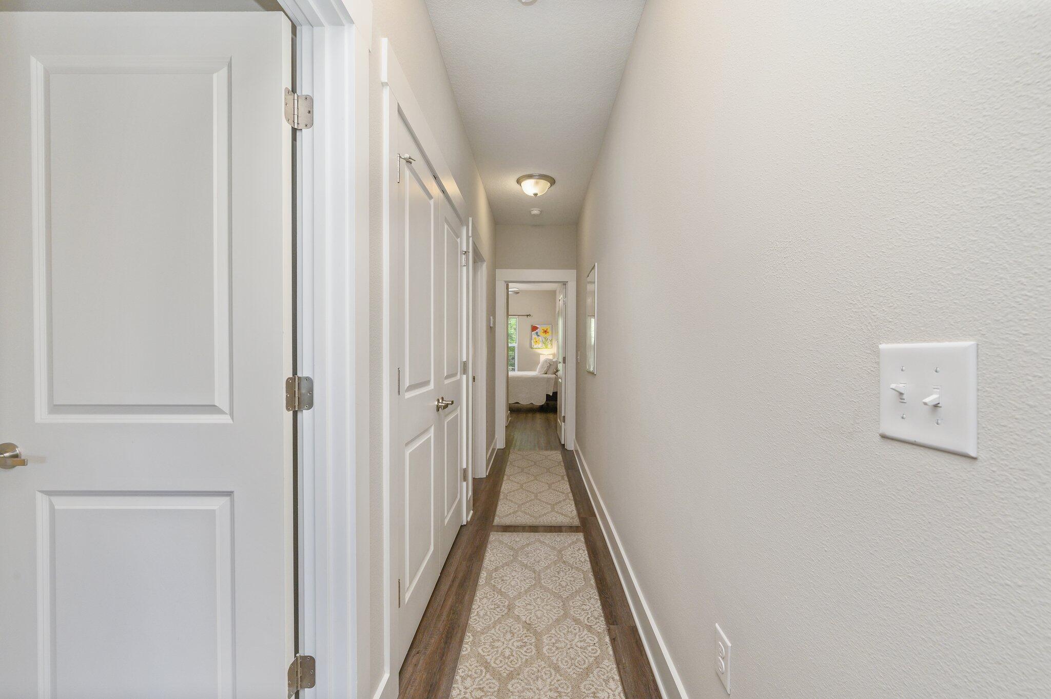 280 North Sand Palm Road Freeport, FL 32439 - Photo 16 of 34 a view of a hallway with wooden floor and a bathroom