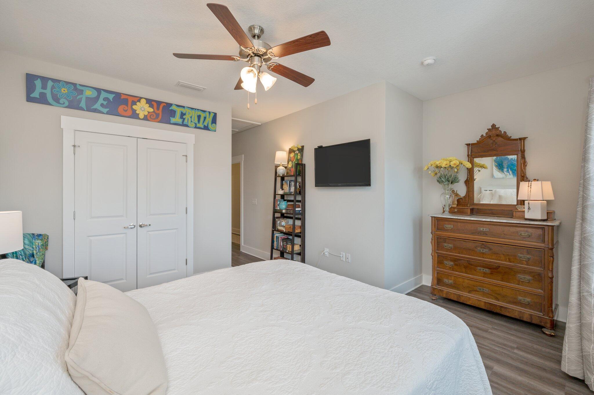 280 North Sand Palm Road Freeport, FL 32439 - Photo 20 of 34 a bedroom with a bed and a chandelier
