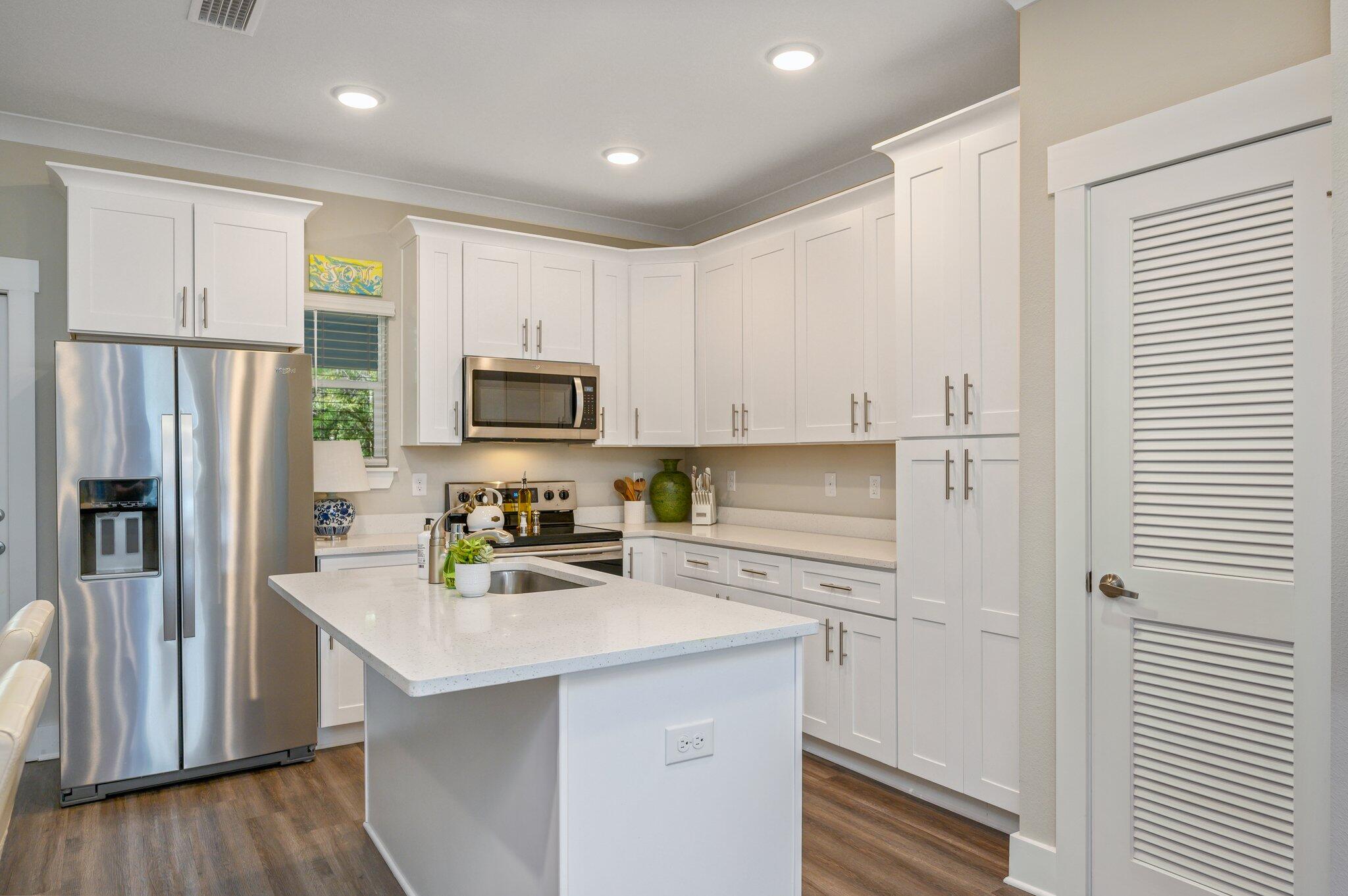 280 North Sand Palm Road Freeport, FL 32439 - Photo 10 of 34 a kitchen with stainless steel appliances a refrigerator sink and microwave