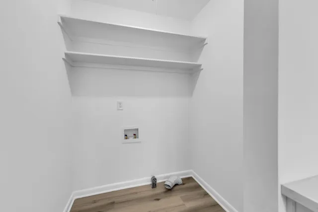 a view of room with window and wooden floor