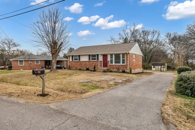 a view of a yard with a house covered in snow