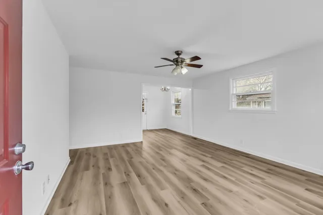 wooden floor in an empty room with a window