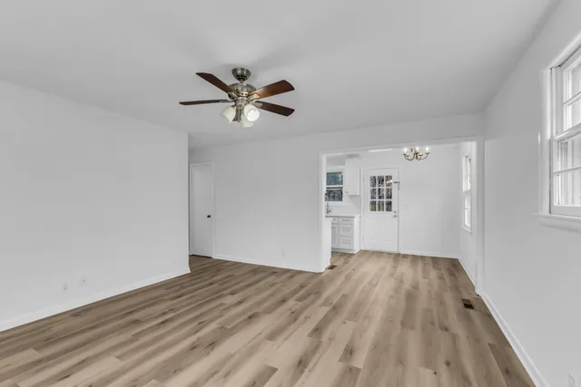 wooden floor in an empty room with a window