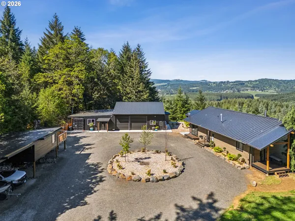 an aerial view of a house with a yard basket ball court and outdoor seating