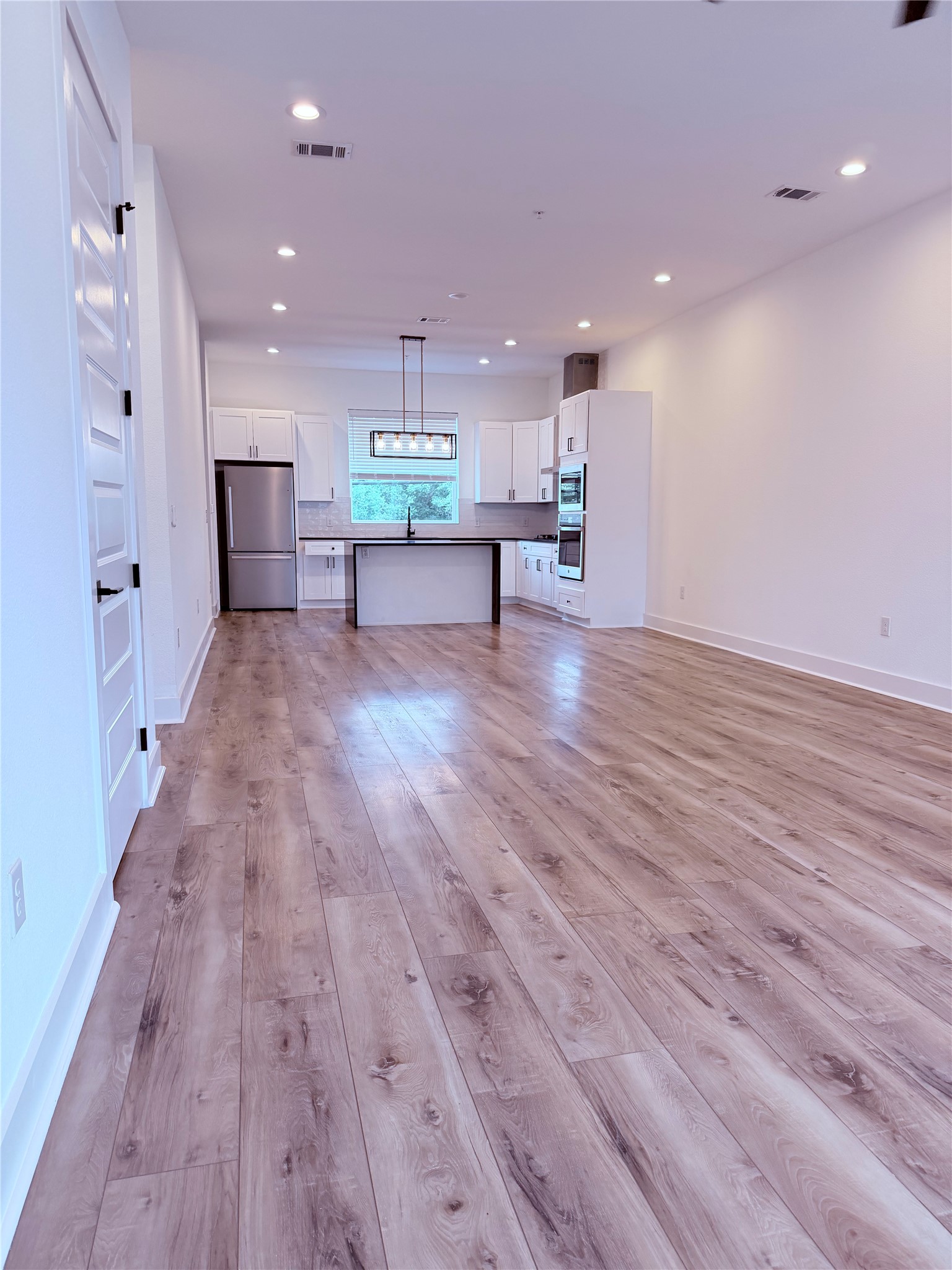 1417 Kramer Lane, Unit 7 Austin, TX 78758 - Photo 24 of 24 A luminous living area seamlessly flows into a sleek kitchen, presenting an inviting open floorplan.