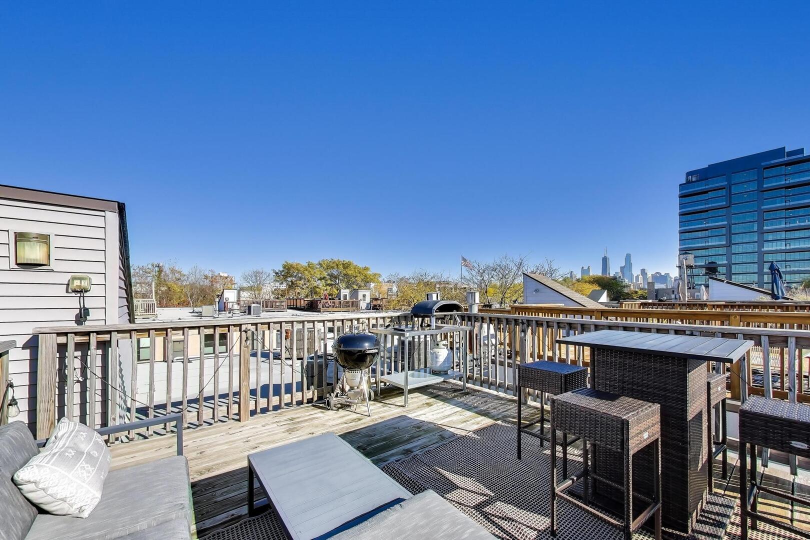 400 North Racine Avenue, Unit 204 Chicago, IL 60642 - Photo 21 of 22 a view of a balcony with wooden floor and outdoor seating