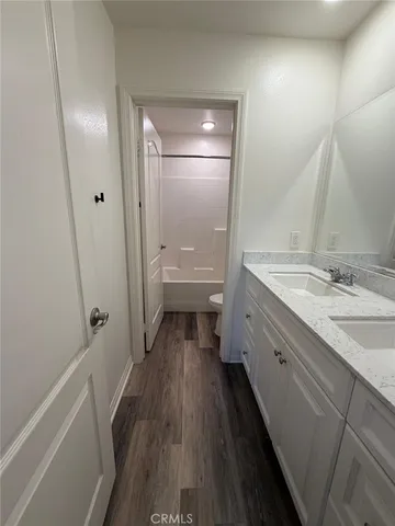 a kitchen with kitchen island granite countertop a stove and a wooden floor